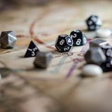 Close-up of detailed miniatures and dice on a black and gold RPG table surface