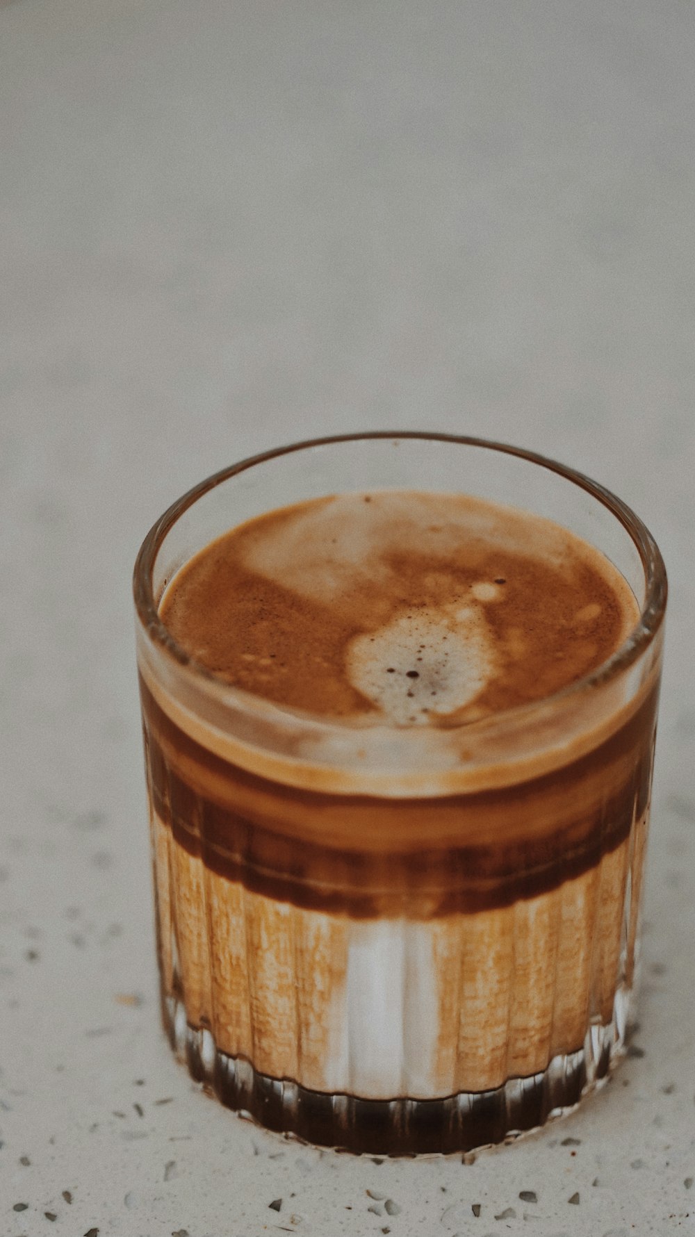 clear drinking glass with brown liquid