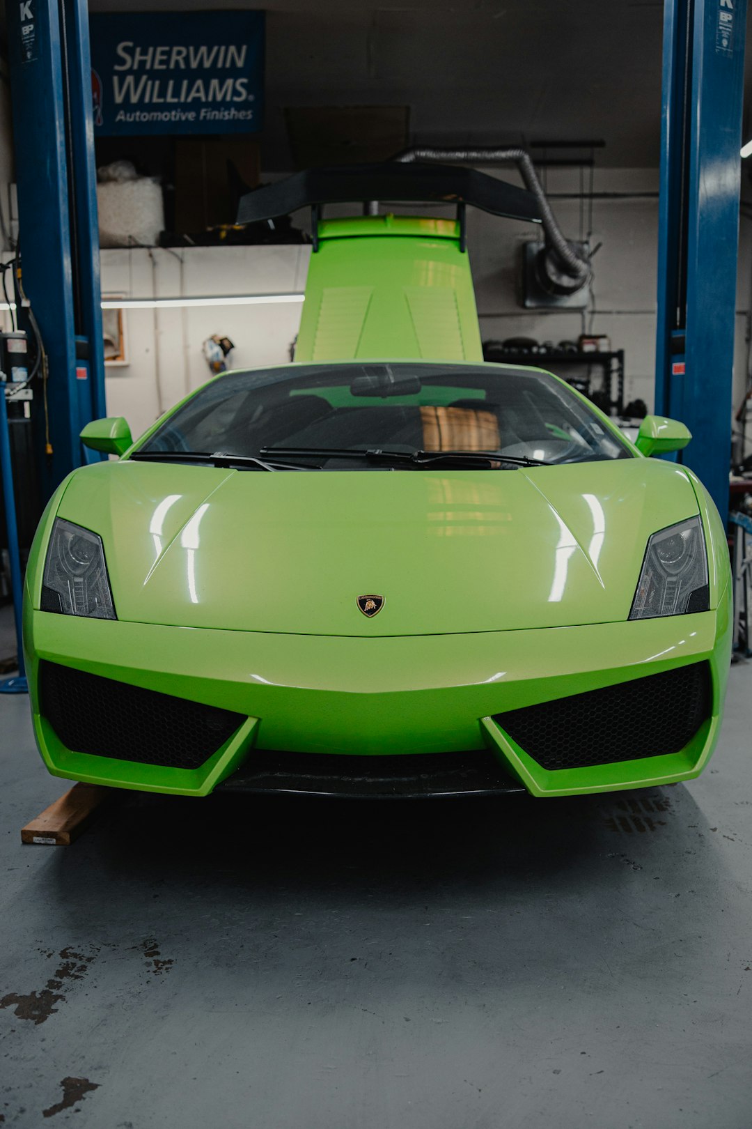 green lamborghini aventador parked in garage