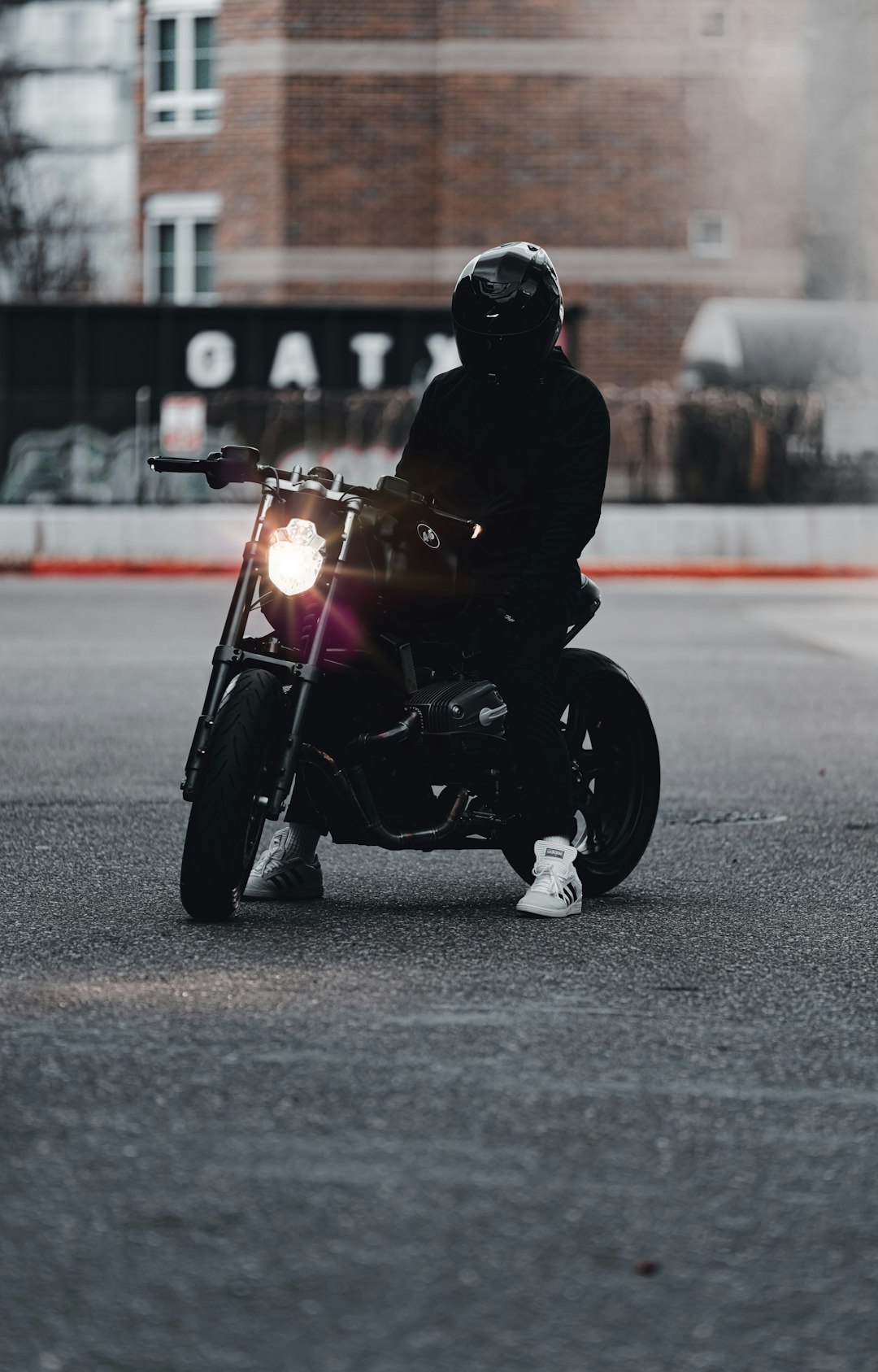 man in black jacket riding motorcycle on road during daytime