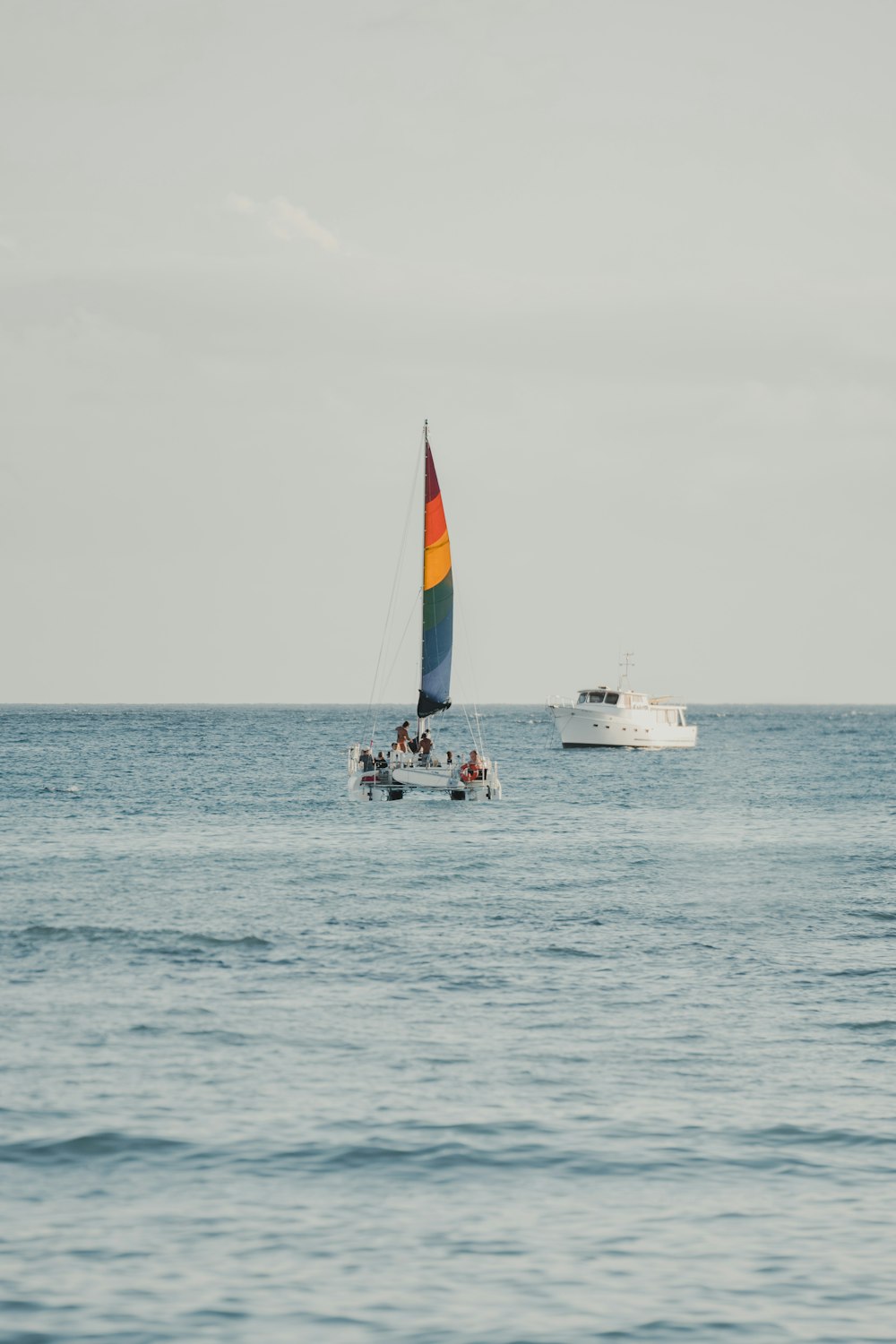 white and red sail boat on sea during daytime