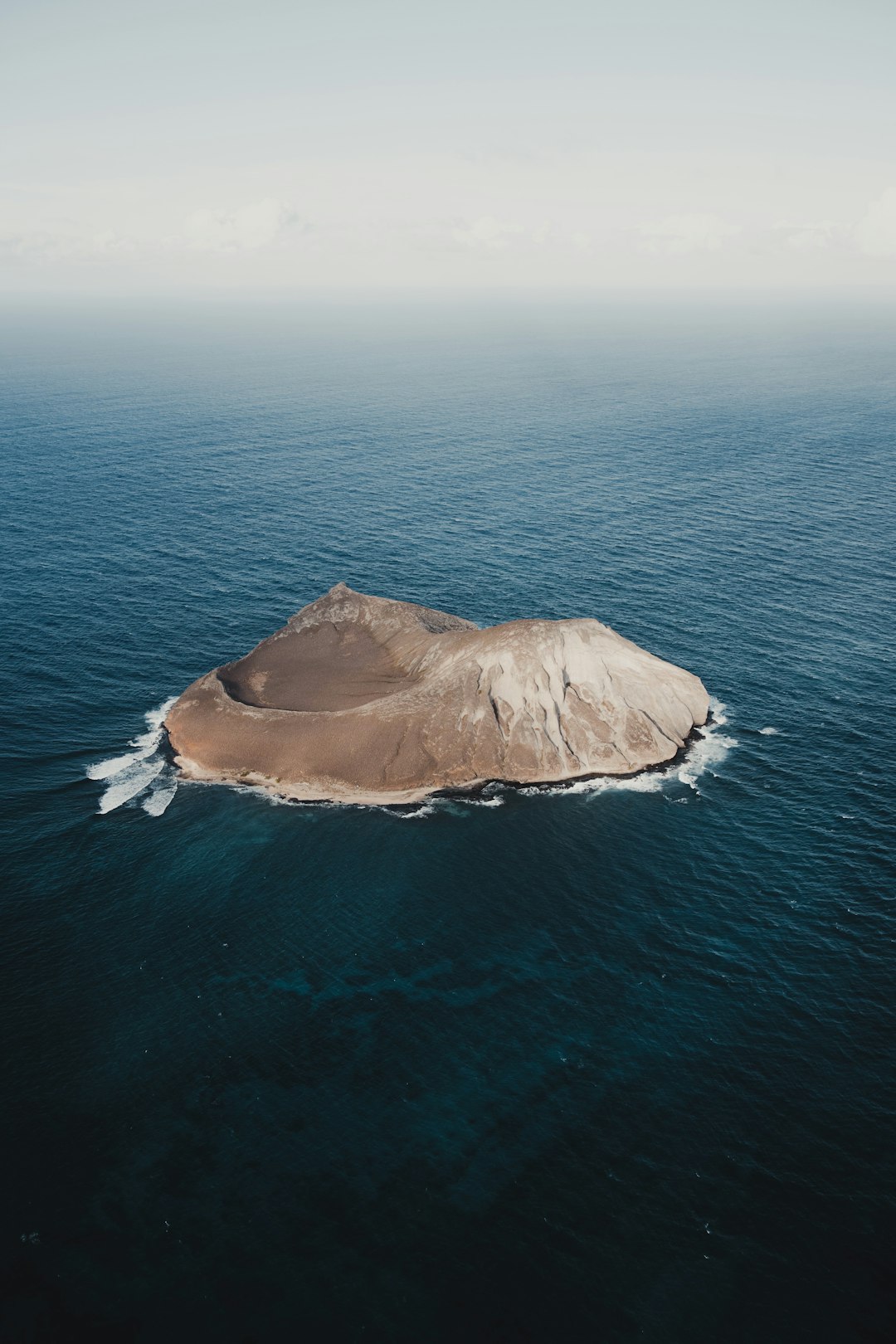 brown rock formation on sea during daytime