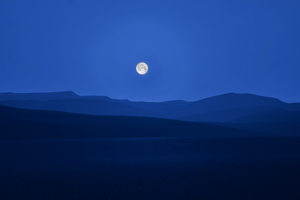 full moon over the mountains