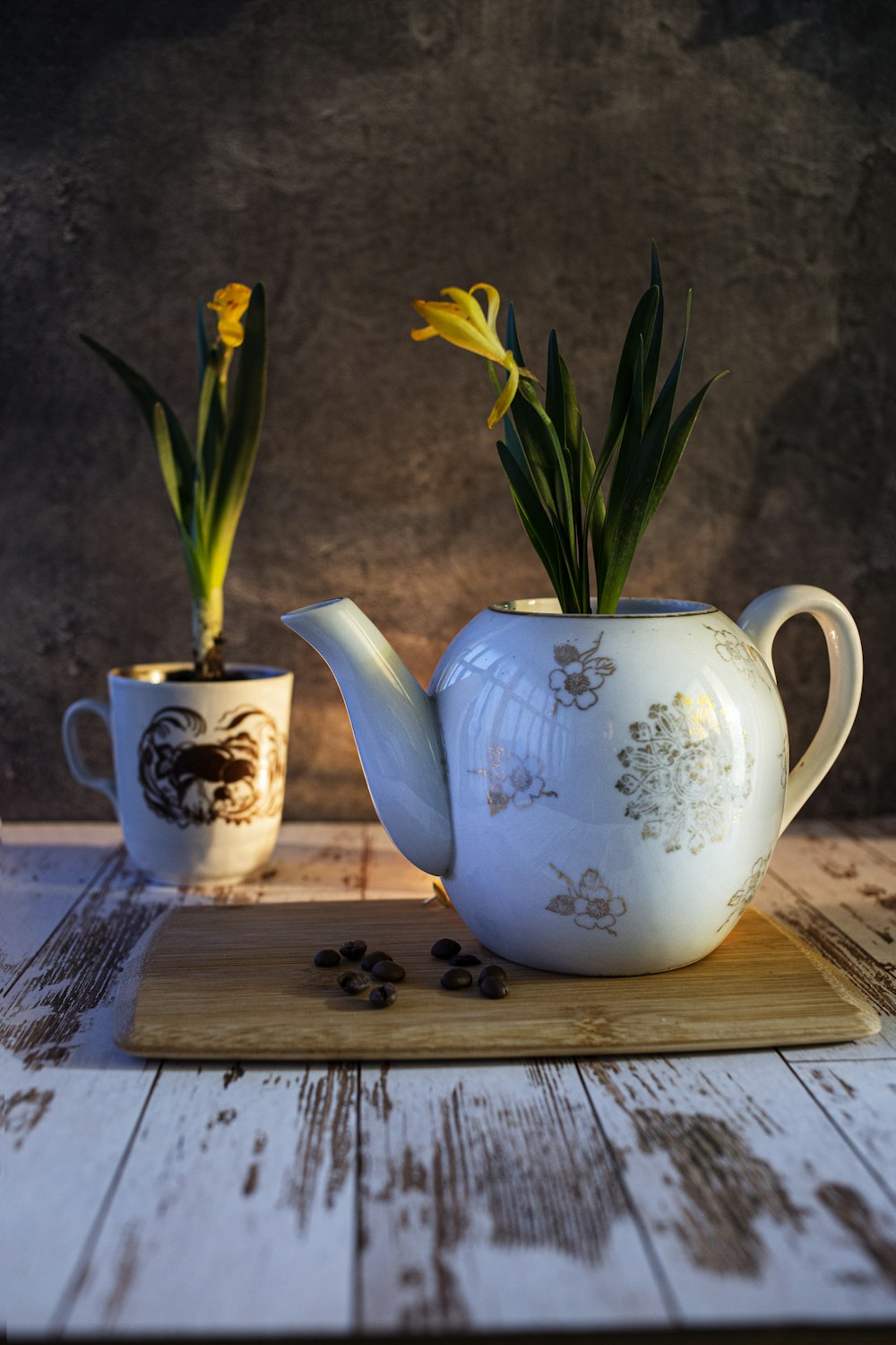 white and blue floral ceramic teapot on brown wooden table