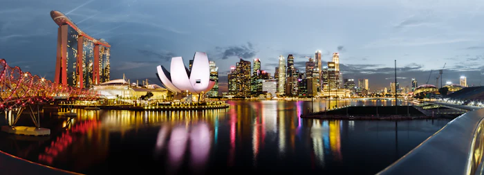 Singapore skyline reflected in Marina Bay at dusk
