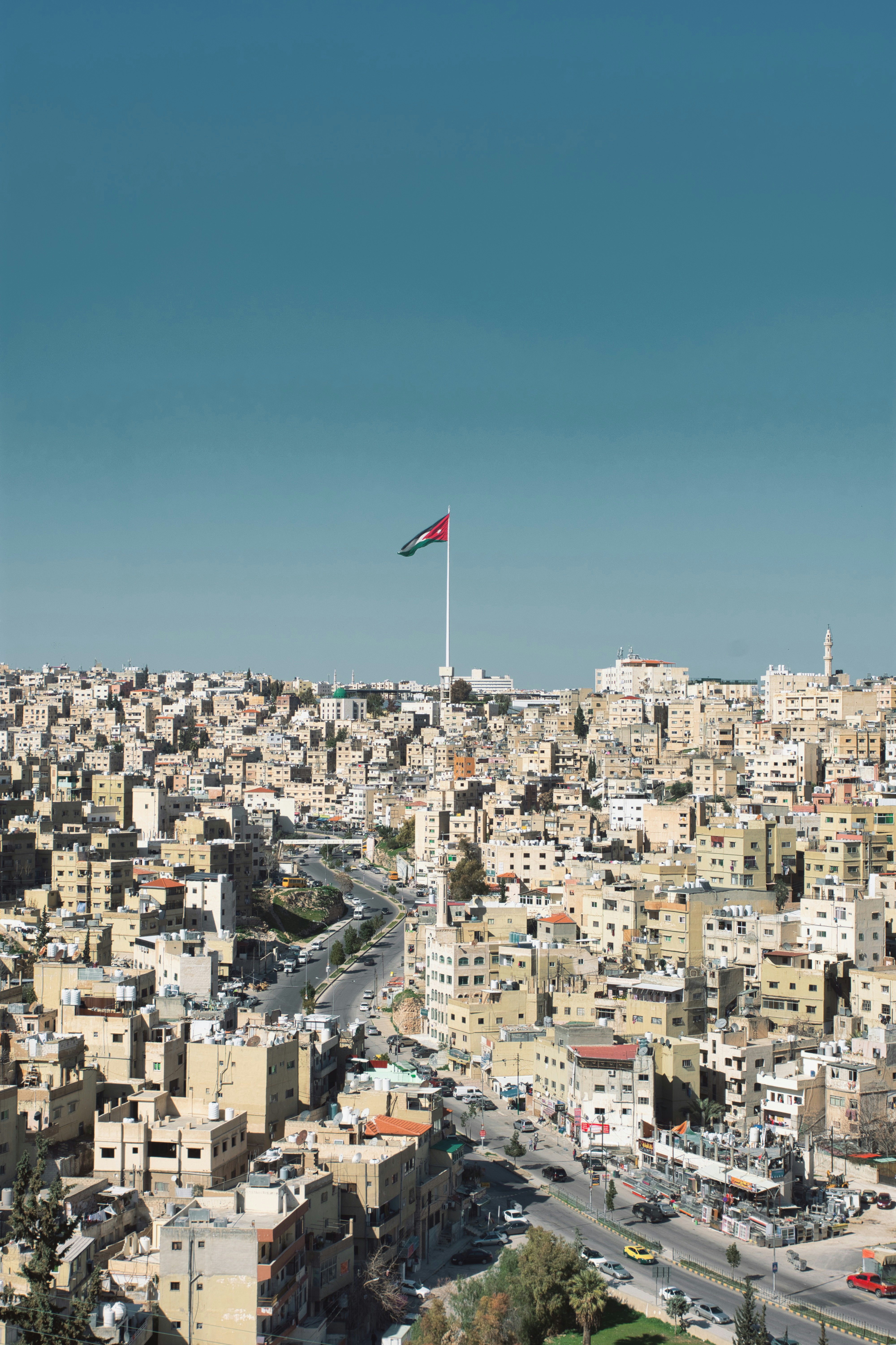 A large Jordanian flag flies over a neighbourhood in Amman, Jordan.
