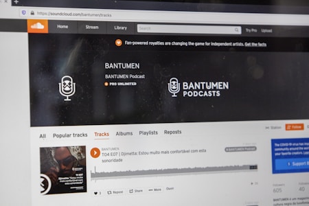 A computer screen displaying a website of an audio streaming service. The website showcases a podcast called BANTUMEN with the description 'Pro Unlimited.' There is a navigation bar with options including Home, Stream, Library, and more. A music wave graphic is visible below, along with a play button, social media interaction options such as re-post, share, and add to playlists. A banner at the top talks about fan-powered royalties, and there is a COVID-19 information widget to the side.