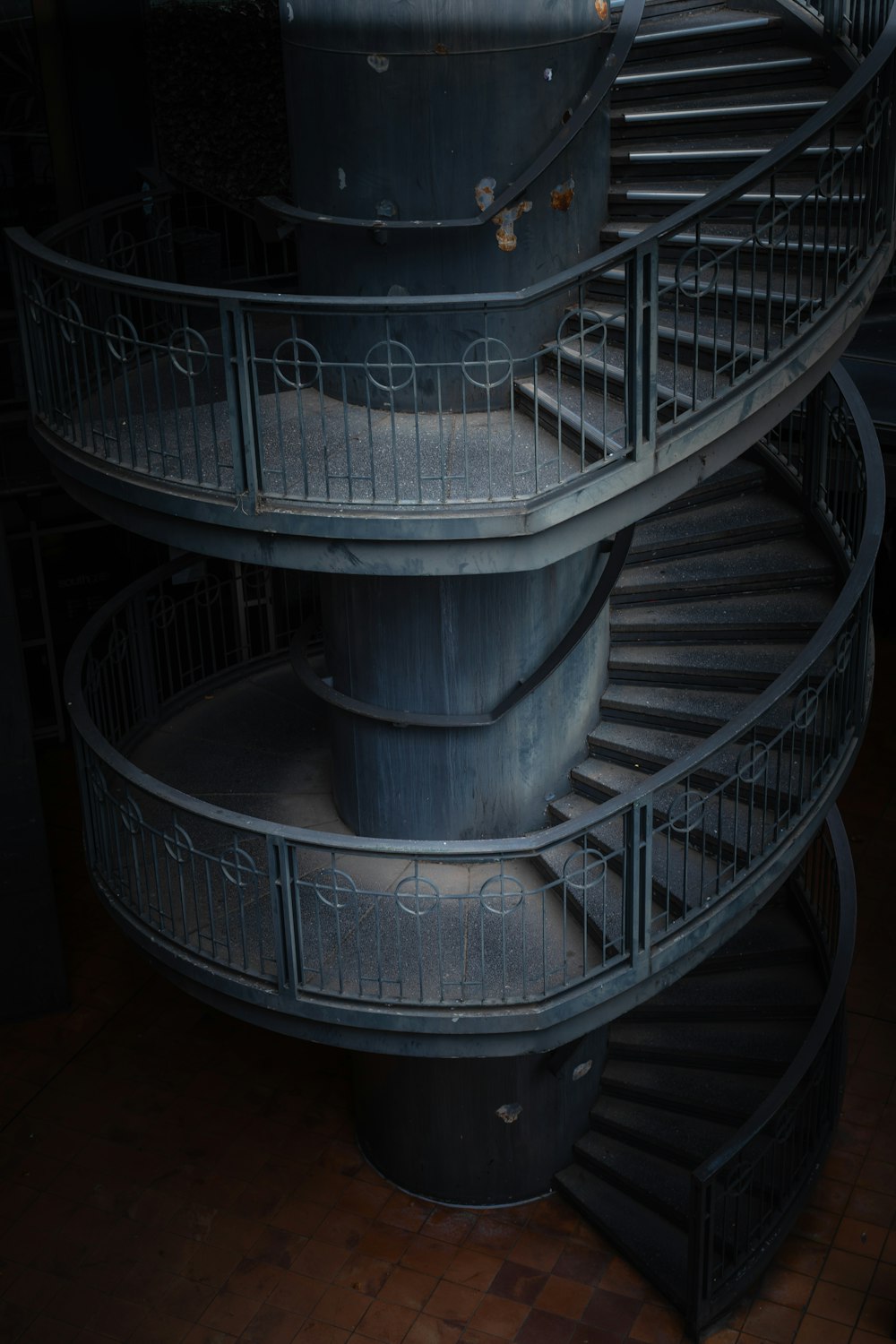 gray spiral staircase with stainless steel railings