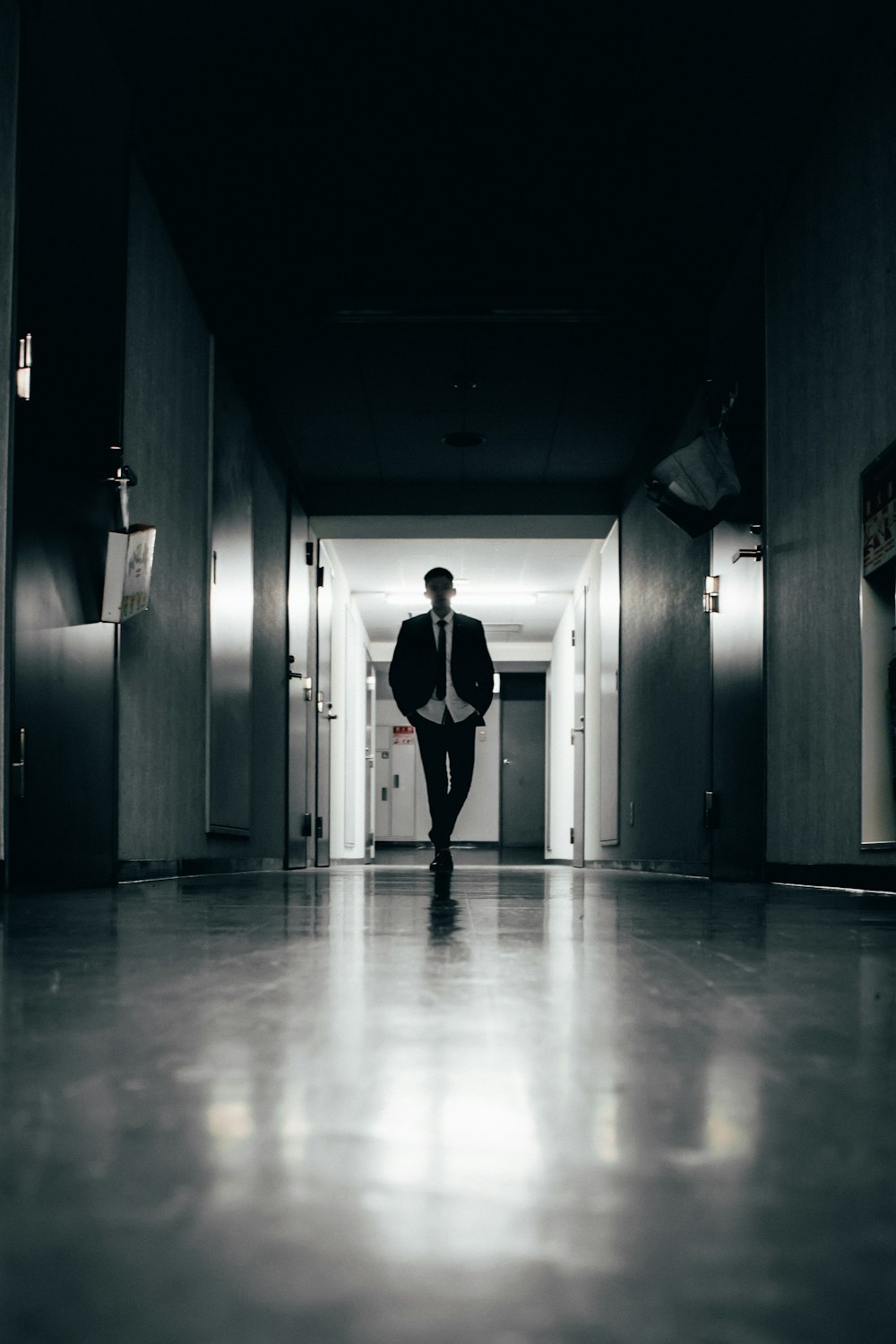 woman in black and white dress walking on hallway