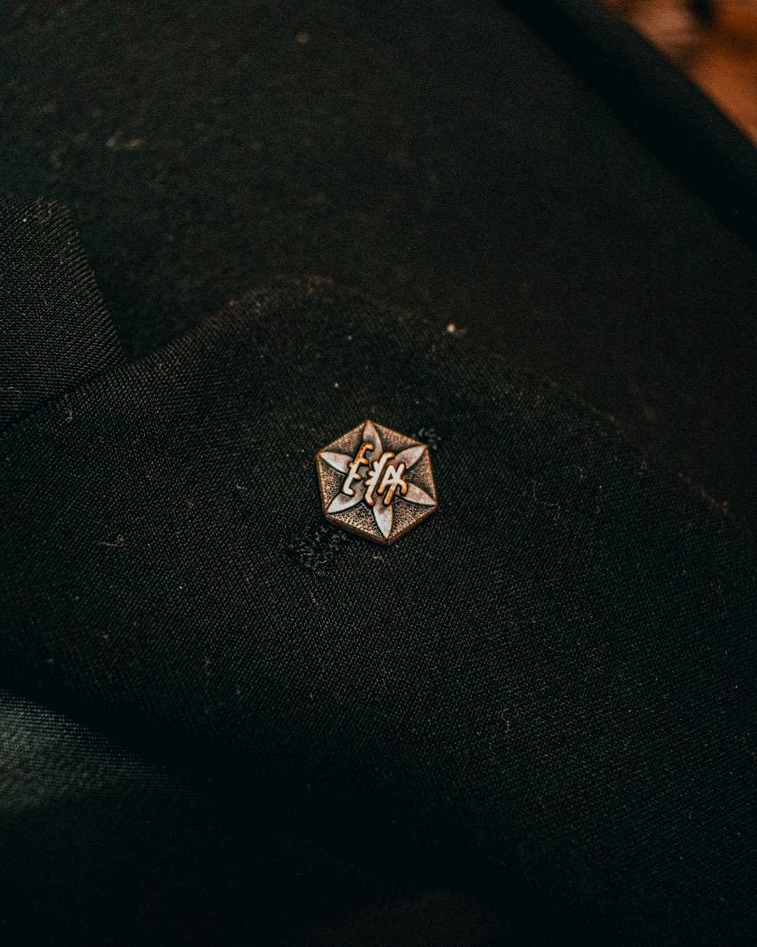 silver diamond ring on black textile