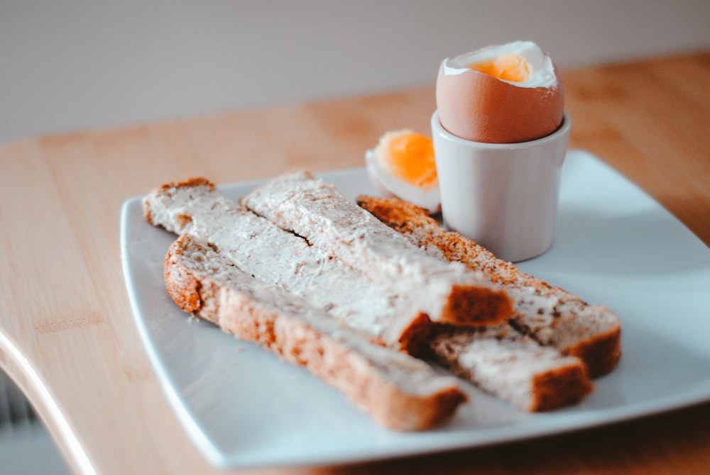 sliced bread with white cream on white ceramic plate