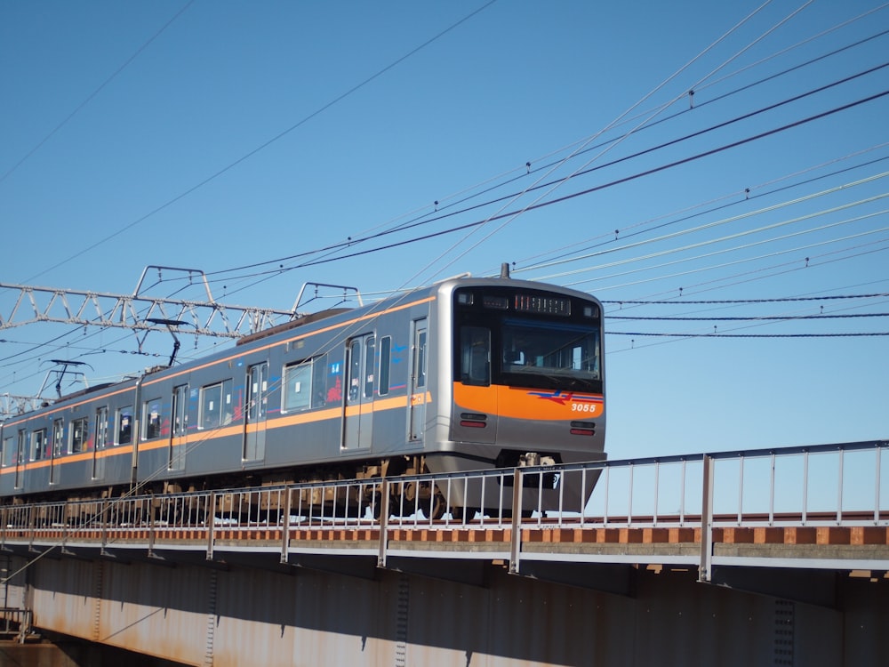 white and blue train on rail tracks during daytime