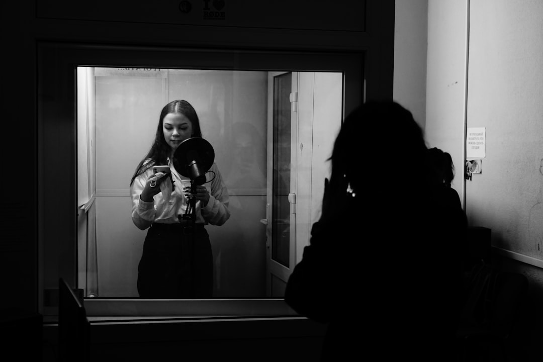 woman in black coat standing in front of mirror