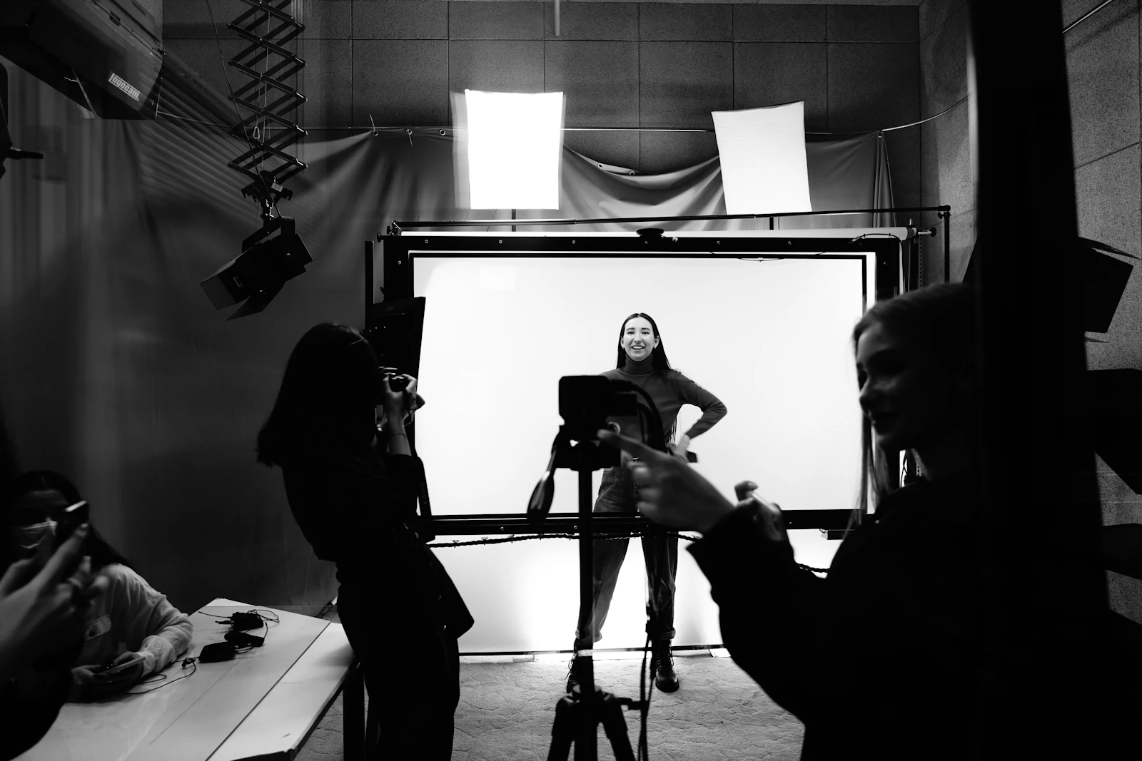 Black and white behind-the-scenes view of a studio portrait session