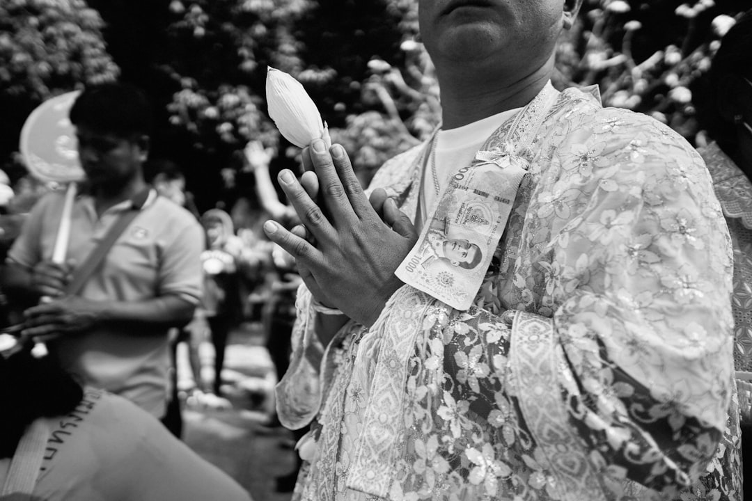 woman in floral dress holding a heart shaped wooden ornament