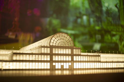 A vibrant 3D architectural model glowing under soft studio lights.