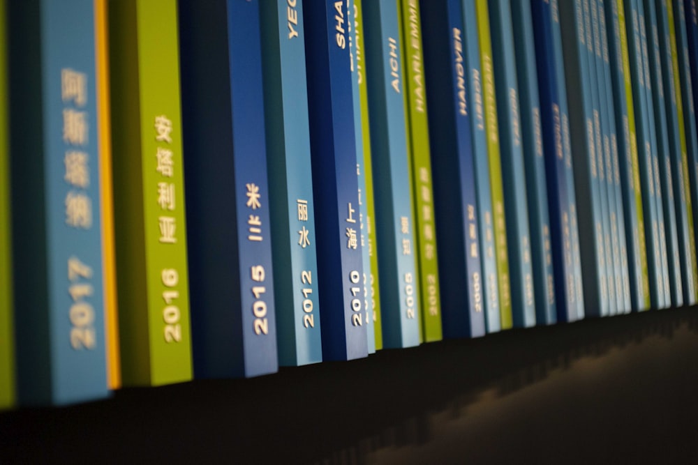 a row of books sitting on top of a shelf