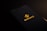 A smartphone screen displaying the Binance logo with yellow text and an icon in the center against a dark background.
