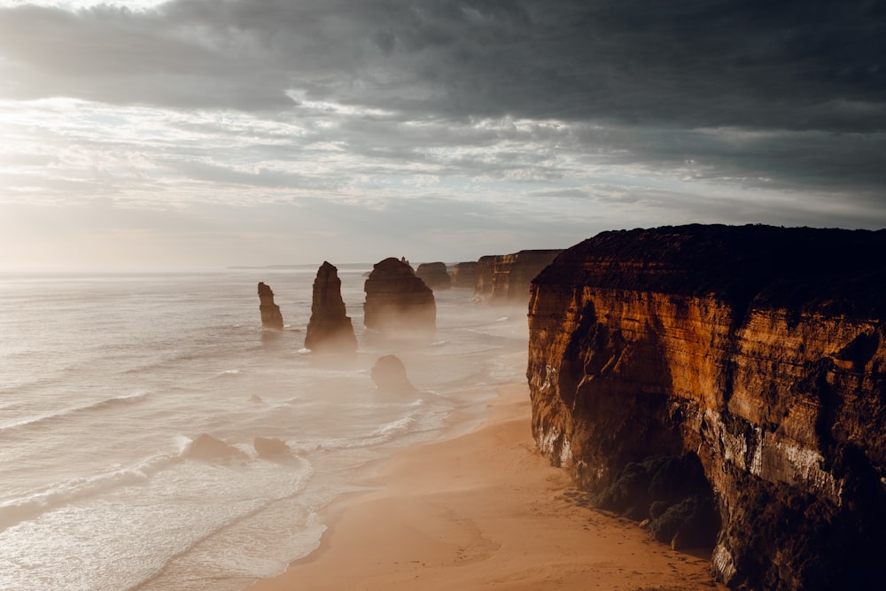 brown rock formation on beach during daytime