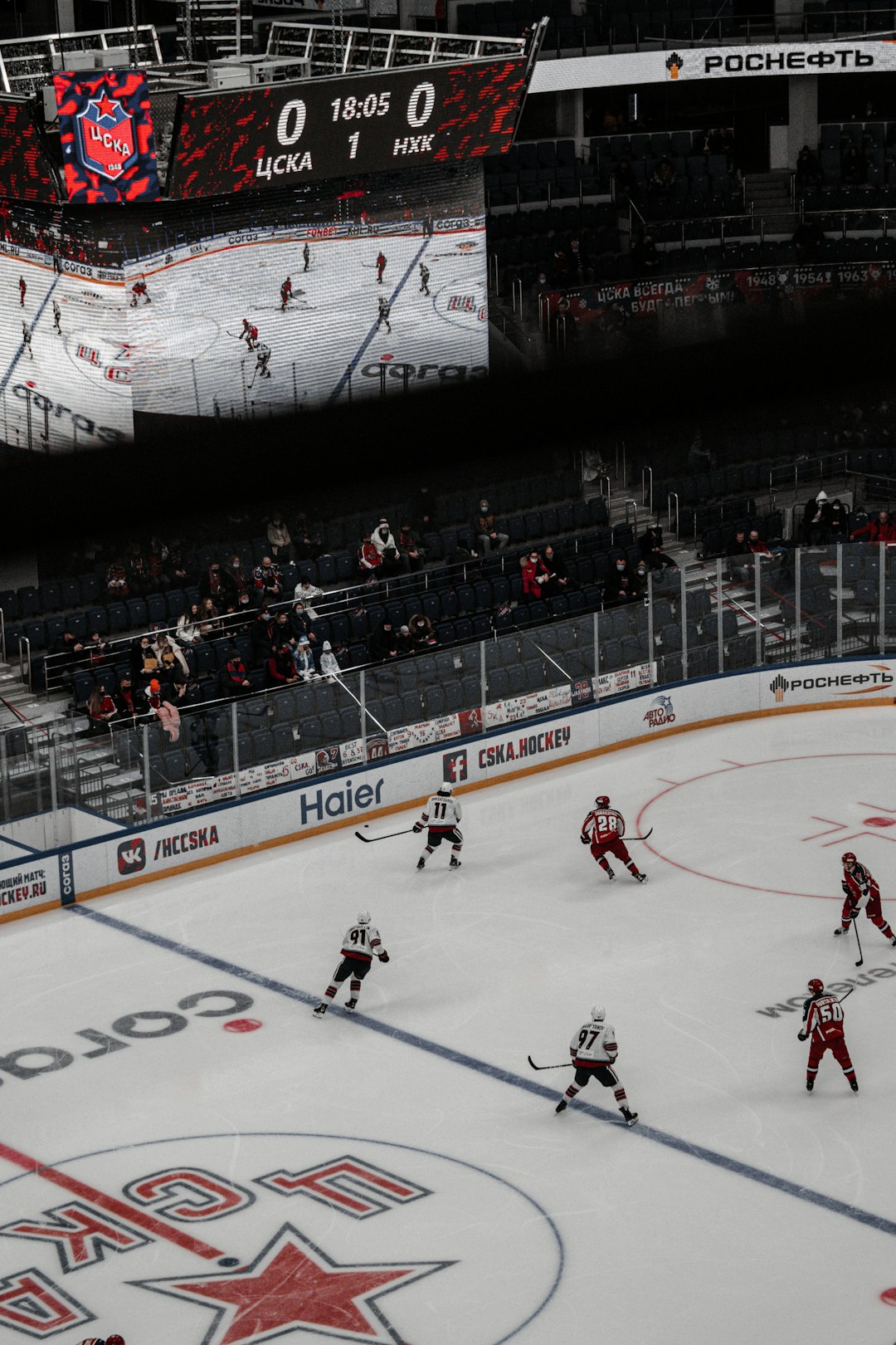 people playing ice hockey inside stadium