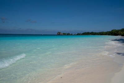 A tranquil beach with crystal-clear water and soft white sand.