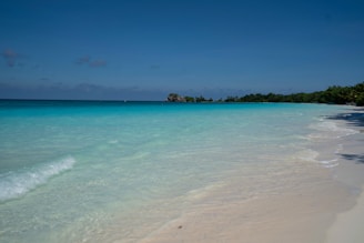 A tranquil beach with soft sand and clear water.