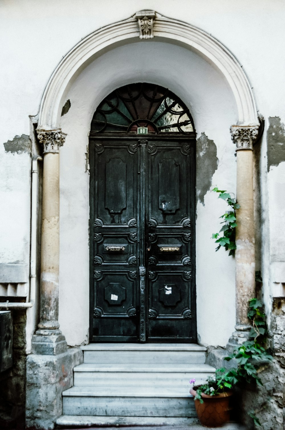 black wooden door on white concrete building