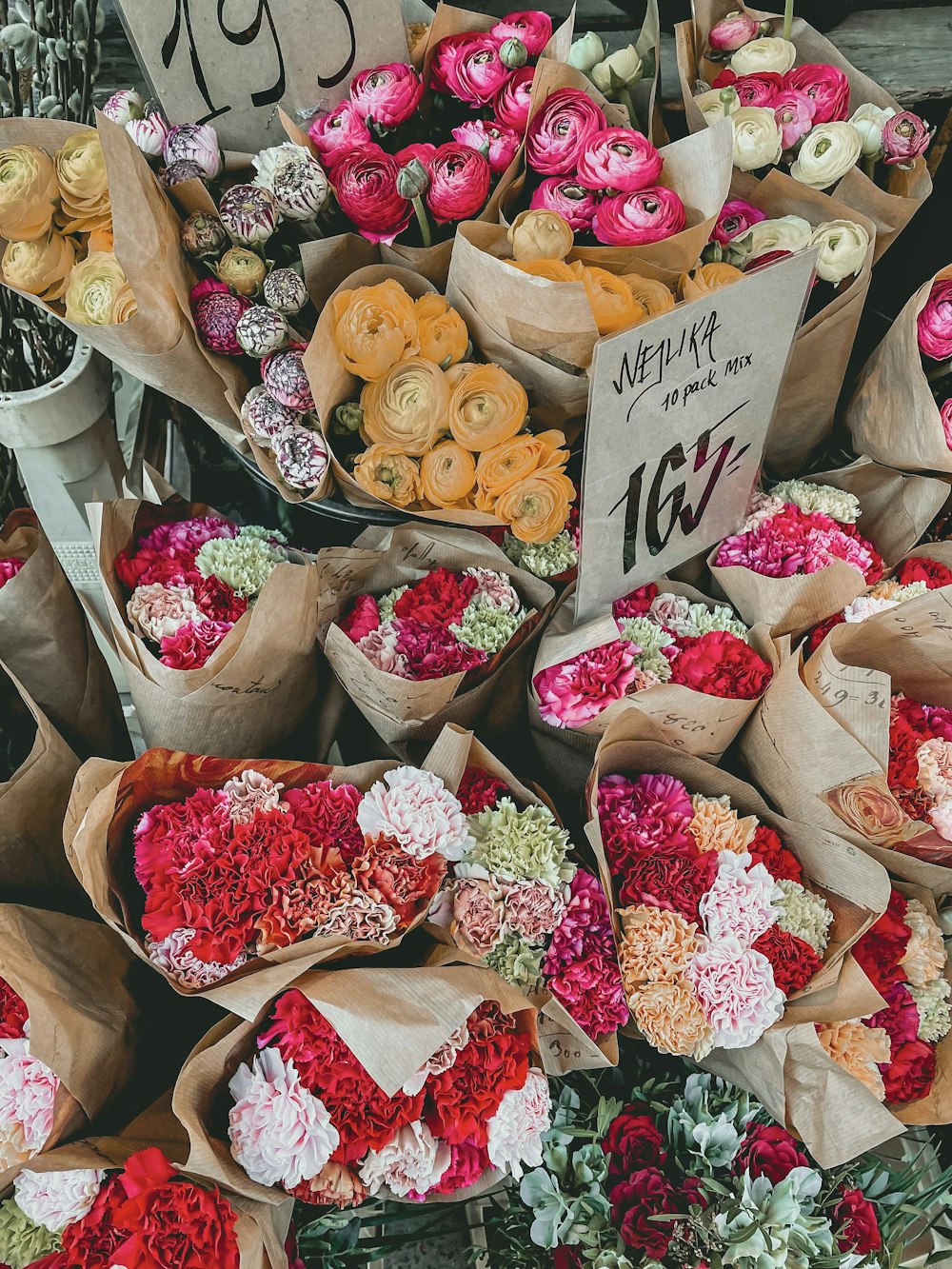 pink and white roses in brown paper bags