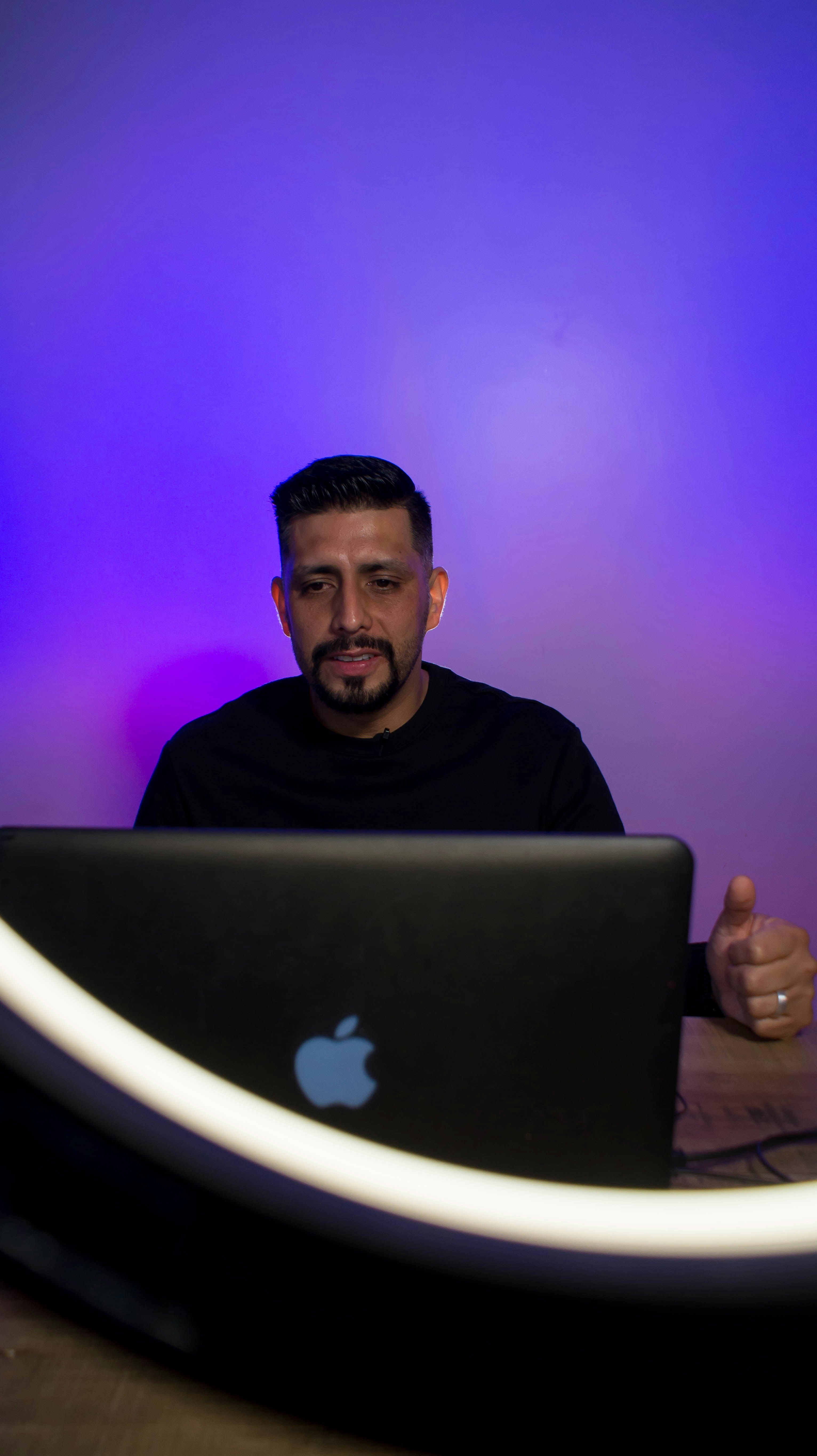 man in black crew neck shirt sitting on white chair