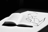 white book page with black earbuds