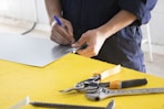 person holding blue and silver scissors