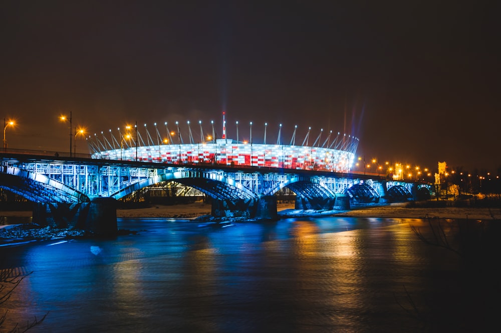 lighted bridge over water during night time