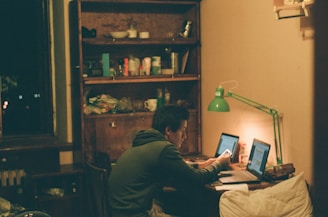 man in black jacket using laptop computer