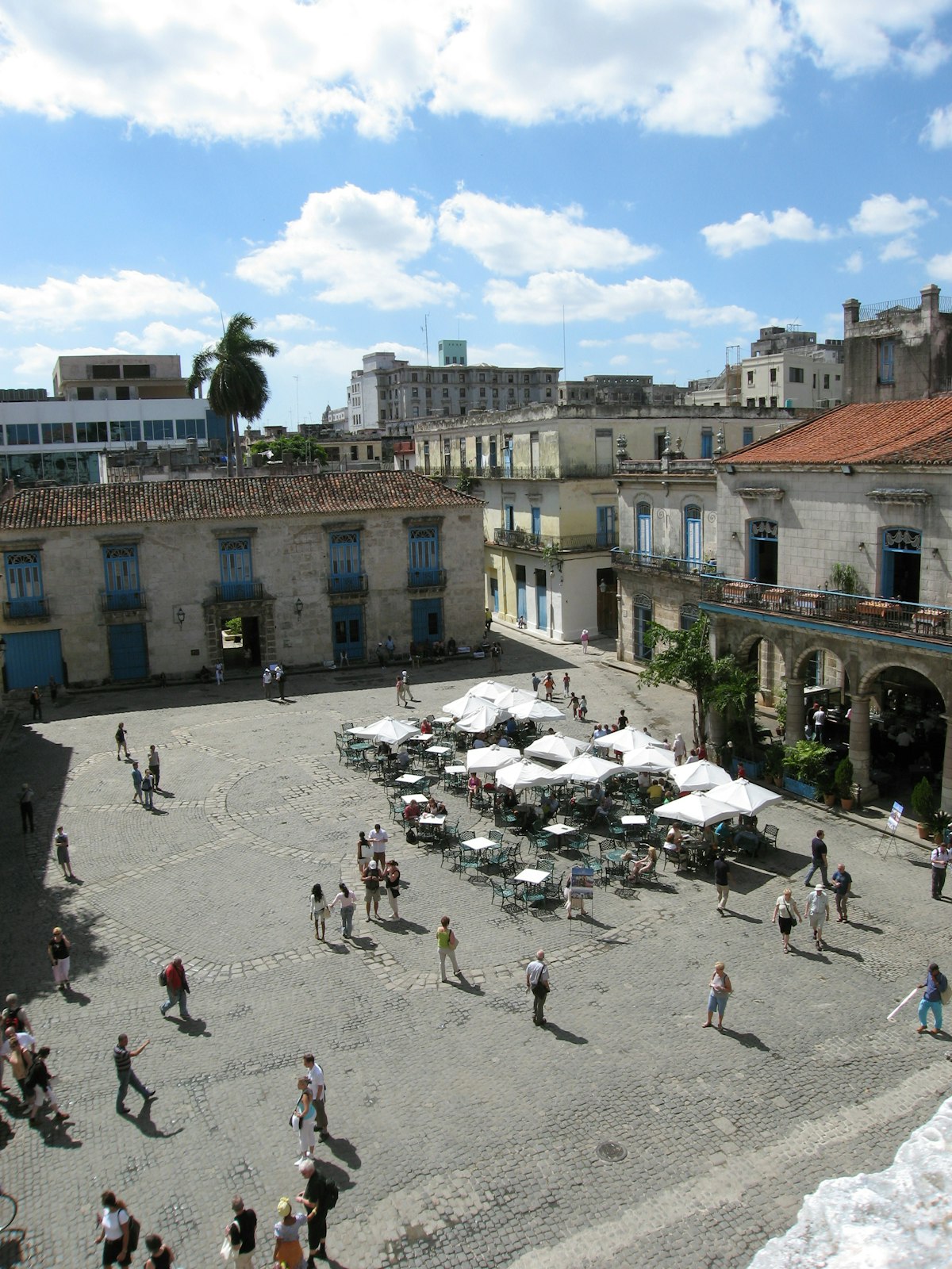 Havana April — aerial view of Plaza de la Catedral in Old Havana, cobblestone square with white cafe umbrellas and colonial arcades