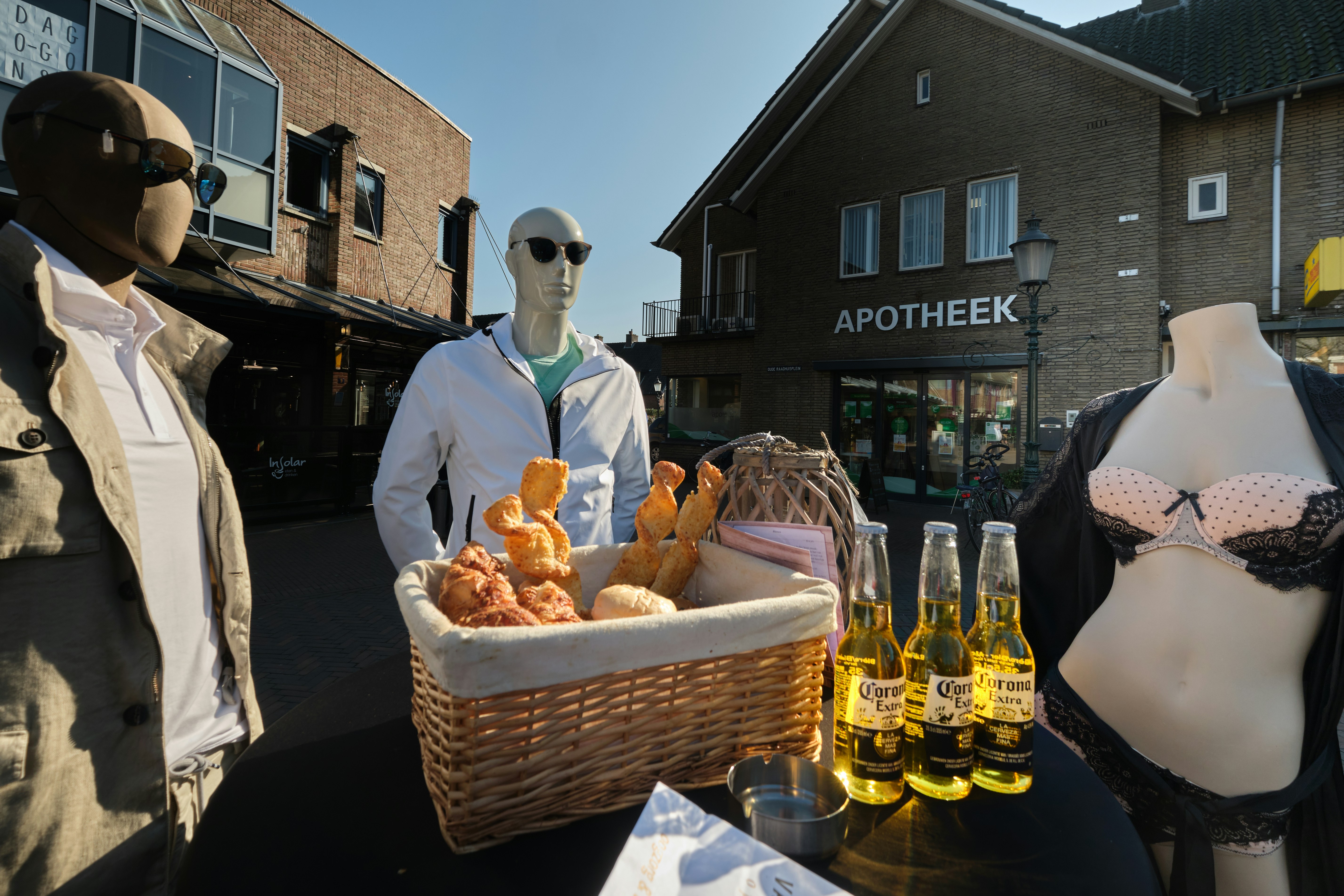 man in black suit standing beside brown wicker basket with bread