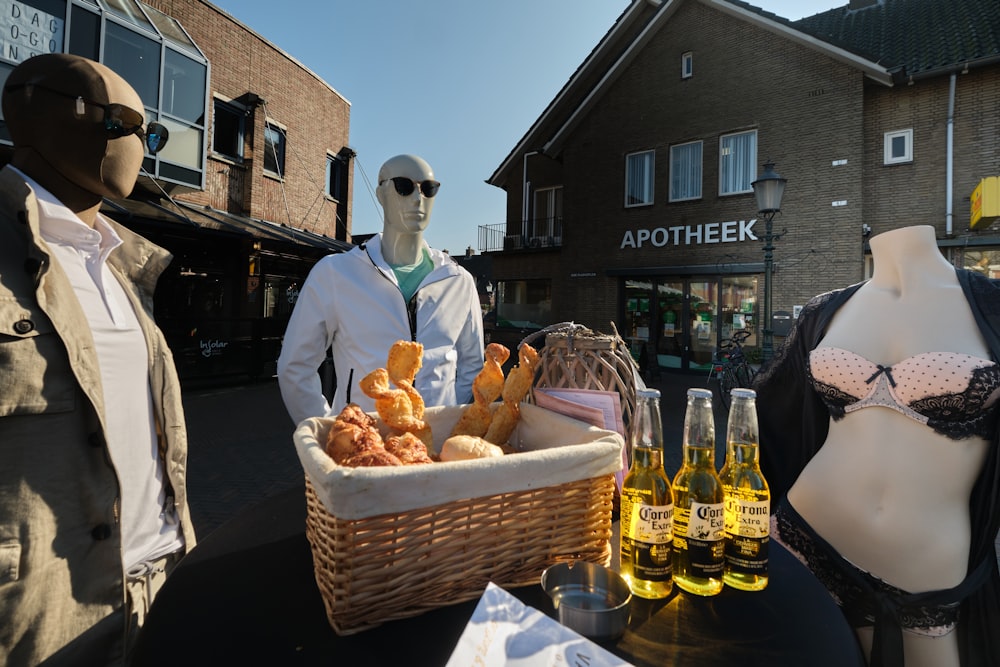 man in black suit standing beside brown wicker basket with bread