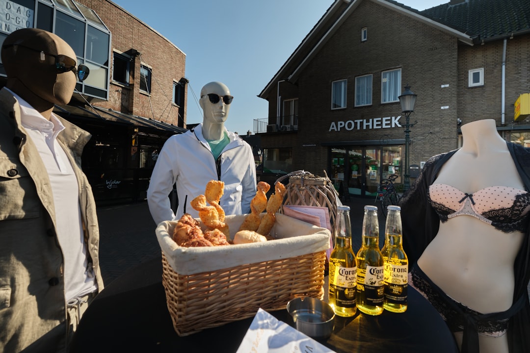 man in black suit standing beside brown wicker basket with bread