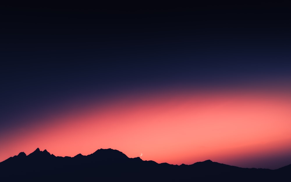 silhouette of mountain during sunset