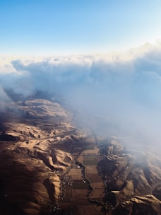 Aerial view of a large open field with distant hills.