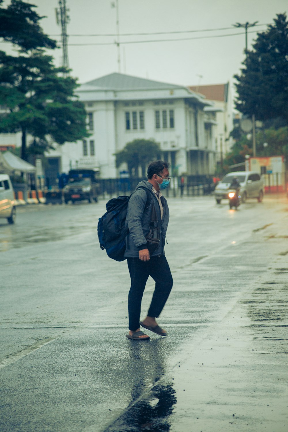 man in black jacket walking on street during daytime