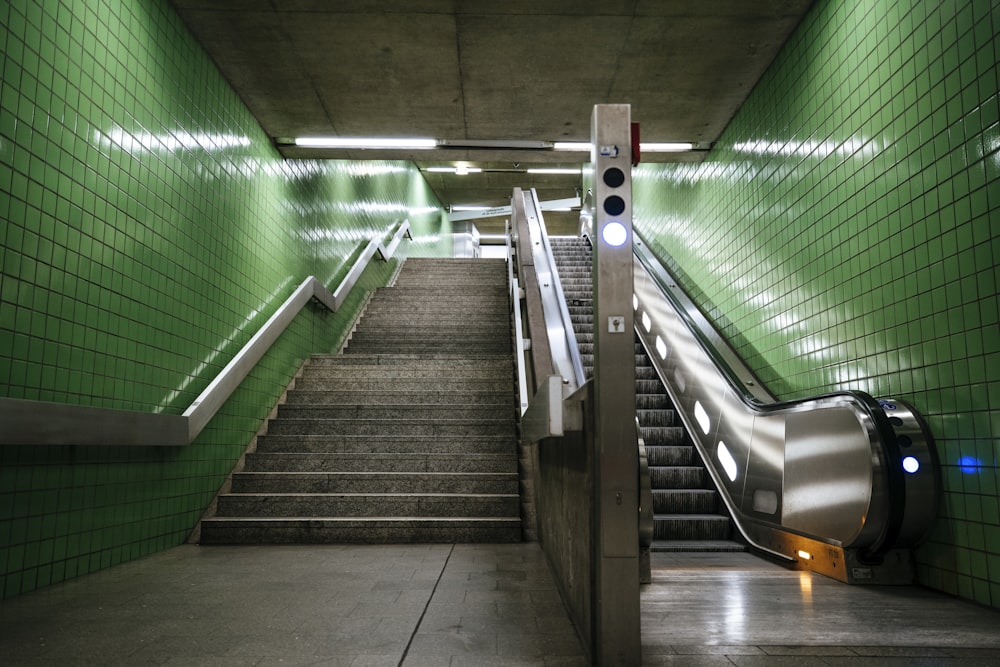 gray concrete stairs with green metal railings