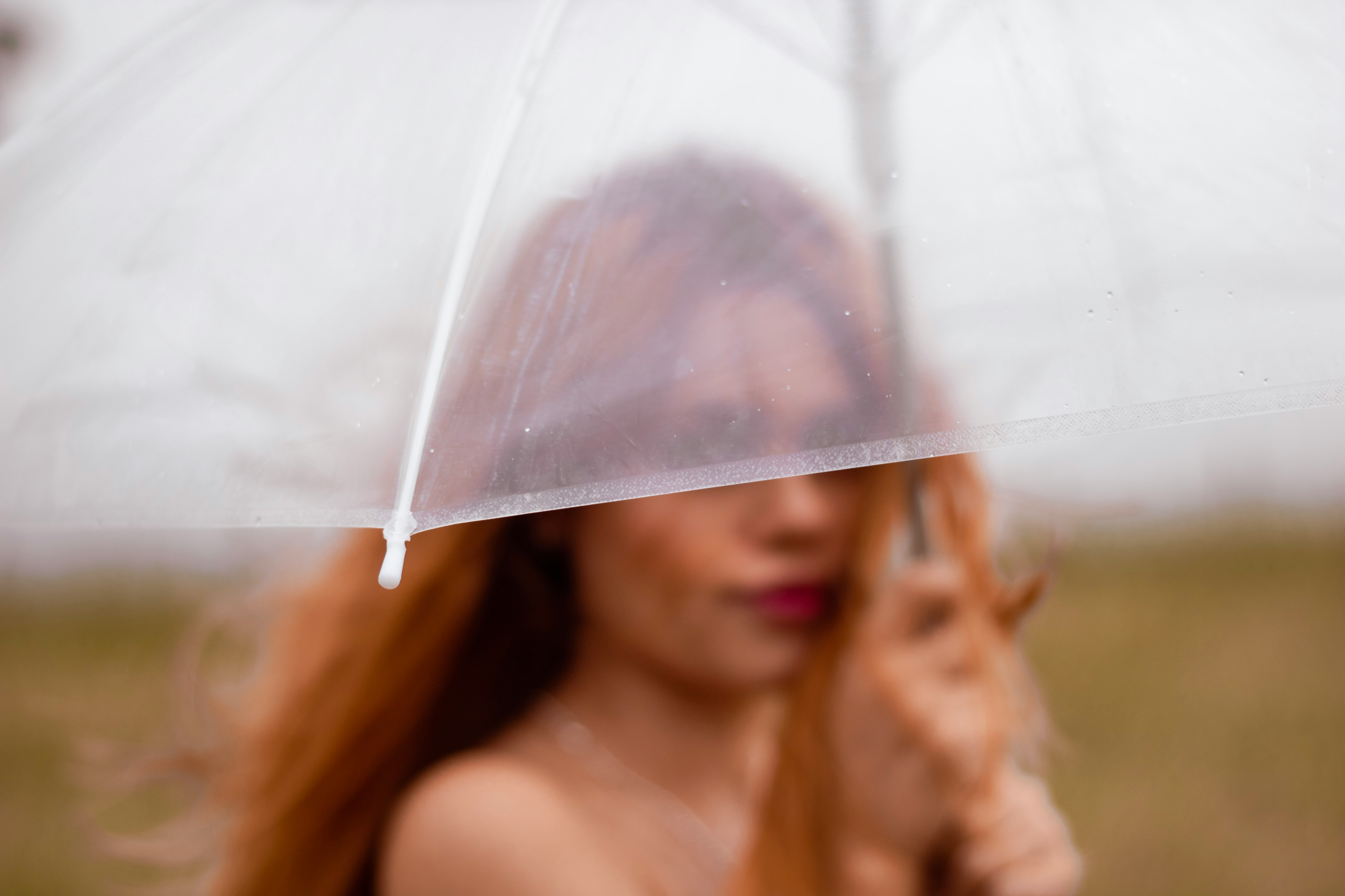 woman holding white umbrella during daytime