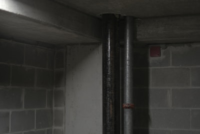 Close-up of a radon testing device placed in a basement corner.