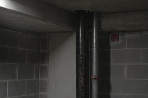 Close-up of radon detector placed near a basement wall.