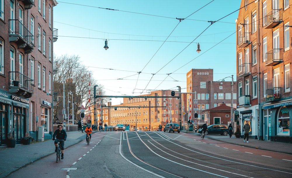 people walking on sidewalk near buildings during daytime