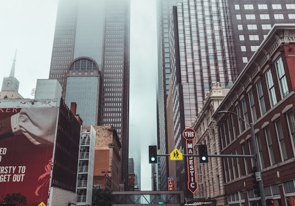 cars on road near high rise buildings during daytime