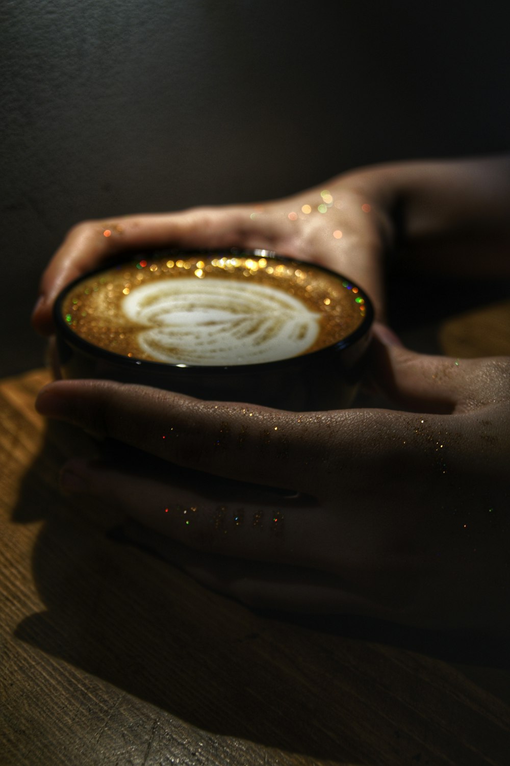 person holding black ceramic mug with white liquid