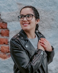 woman in black leather jacket wearing black framed eyeglasses