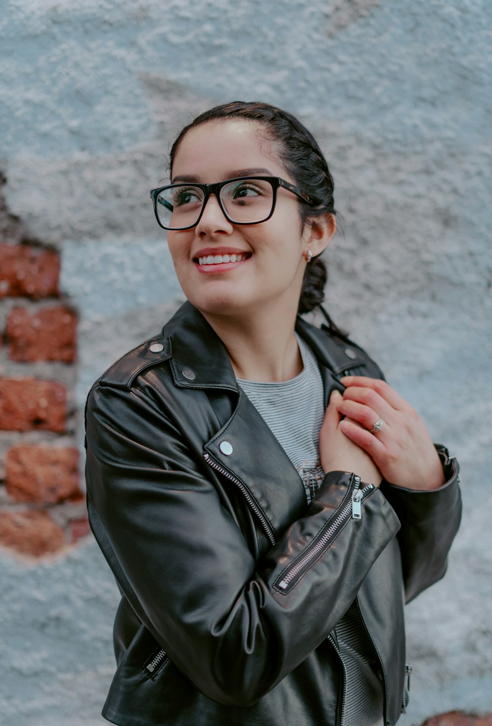 woman in black leather jacket wearing black framed eyeglasses