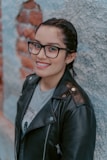 woman in black leather jacket wearing black framed eyeglasses